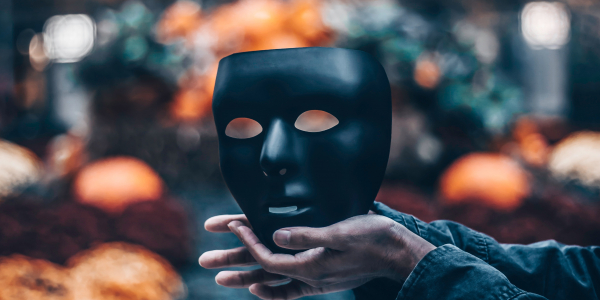 Photo of hands holding black mask by John Noonan on Unsplash